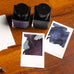 Wearingeul Instant Film Colour Swatch (50 sheets) on a wooden table with two glass ink bottles and shimmering ink swatches, showcasing fountain pen friendly paper.