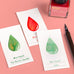 Wearingeul Ink Drop Swatch Cards displayed with fountain pen ink samples, showcasing ink names and a dip pen, highlighting stationery's literary inspiration and quality paper for ink characteristics.