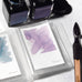Wearingeul Instant Film Colour Swatch (50 sheets) displayed with open fountain pen ink bottles and swatches, alongside a wooden pen holder, showcasing ink characteristics on Impression paper.