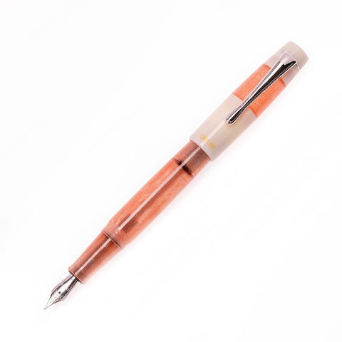OPUS 88 Koloro Pink Extra Fine fountain pen with a glitter-orange acrylic barrel, stainless steel nib, and off-white cap with chrome clip.