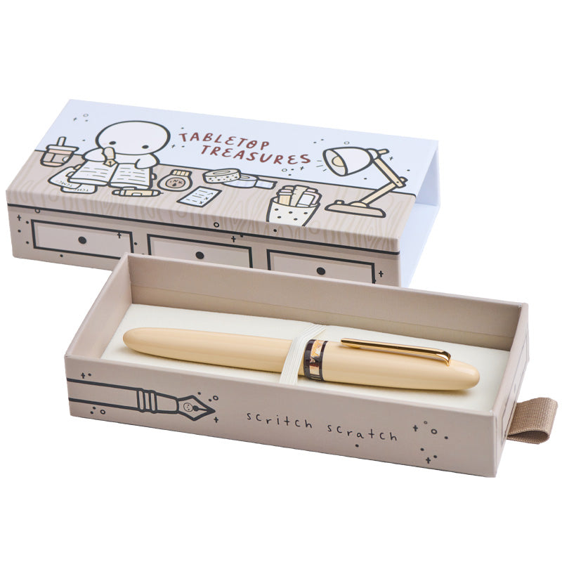 Estie - TheCoffeeMonsterzCo Collab / Gold - Extra Fine fountain pen with an ivory-cream body and gold accents, housed in a custom gift box with whimsical illustrations.