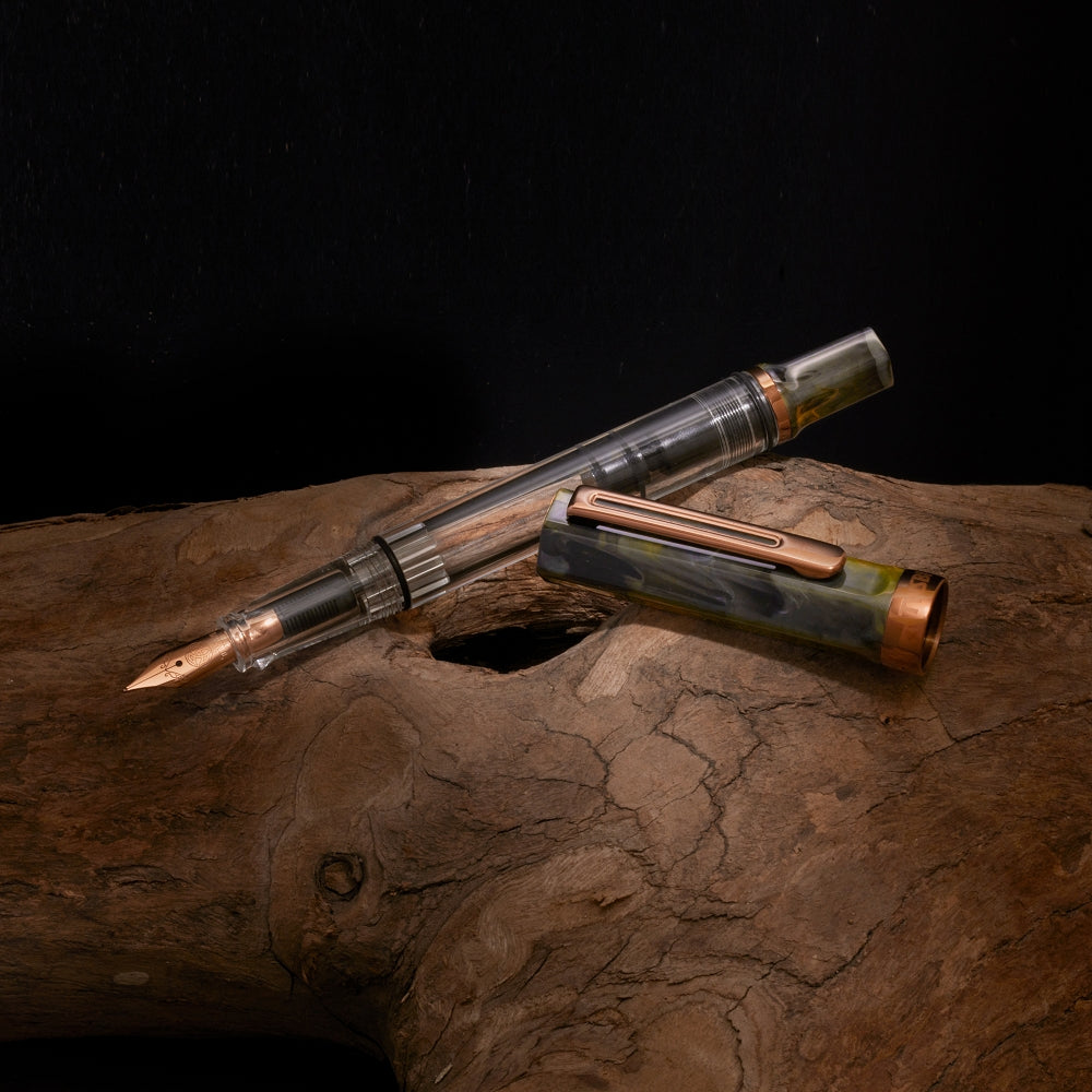 TWSBI ECO fountain pen in Serpentine colourway with copper accents, displayed on a natural wooden surface