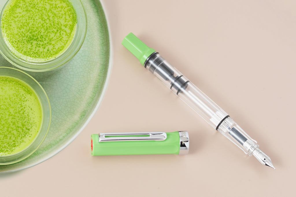 TWSBI ECO fountain pen in Matcha against table top background and with cups of matcha in glasses