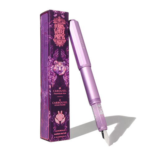 Ferris Wheel Press Aluminium Carousel Fountain Pen - Aurorealis (Medium) with a lilac-purple finish, features a custom ground steel nib, displayed next to its branded box.