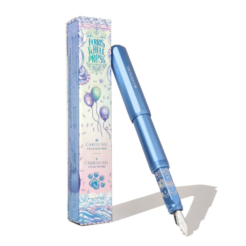 Ferris Wheel Press Aluminium Carousel Fountain Pen - Blue Revelry (Fine) with steel nib and decorative carton featuring pastel balloons, celebrating 15 years of artistry and writing passion.