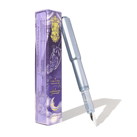 Ferris Wheel Press Aluminium Carousel Fountain Pen - Harlequin Dream (Fine) with steel nib, etched detailing, leaning on its decorative purple and gold box.