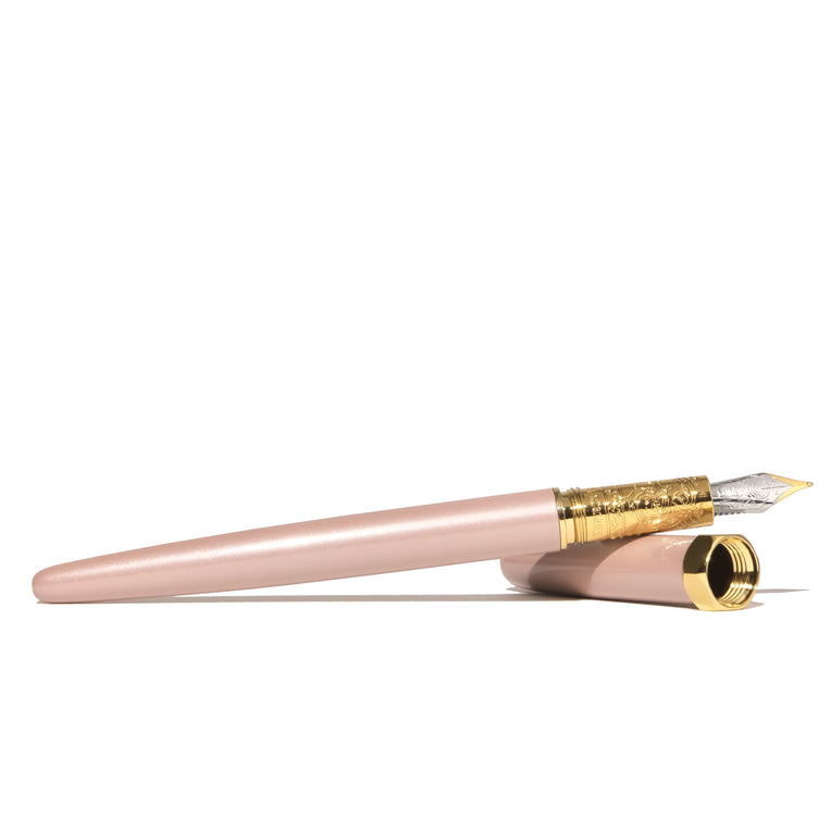 The Bijou Fountain Pen - Huffin Puff Pink (Fine) by Ferris Wheel Press features a two-tone nib and engraved brass grip, embodying elegance and precision.