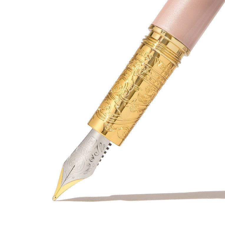 The Bijou Fountain Pen - Huffin Puff Pink (Fine) features a two-tone nib and engraved gold-tone grip section, showcasing Ferris Wheel Press's intricate craftsmanship.