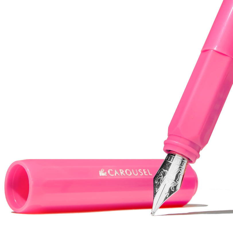 Carousel Fountain Pen - Malibu Blush (Medium) by Ferris Wheel Press, featuring a polished silver nib with decorative engraving and a vibrant pink barrel stamped with “Carousel.”