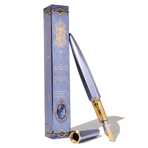 Ferris Wheel Press Marquise Fountain Pen in Pearl Drop Blue, fine steel nib, with a faceted hexagonal design and gold detailing, displayed alongside its decorative box.