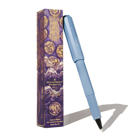 Ferris Wheel Press Roundabout Rollerball Pen in Tides of Midas, featuring a pastel blue design with a decorative purple box, ideal for fountain pen ink customization.