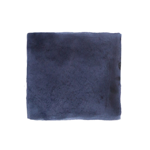 KWZ Ink IG Blue #1 - 60ml, iron gall-based fountain pen ink, shown with a plush navy microfiber cloth, emphasizing its artisanal and unique characteristics.