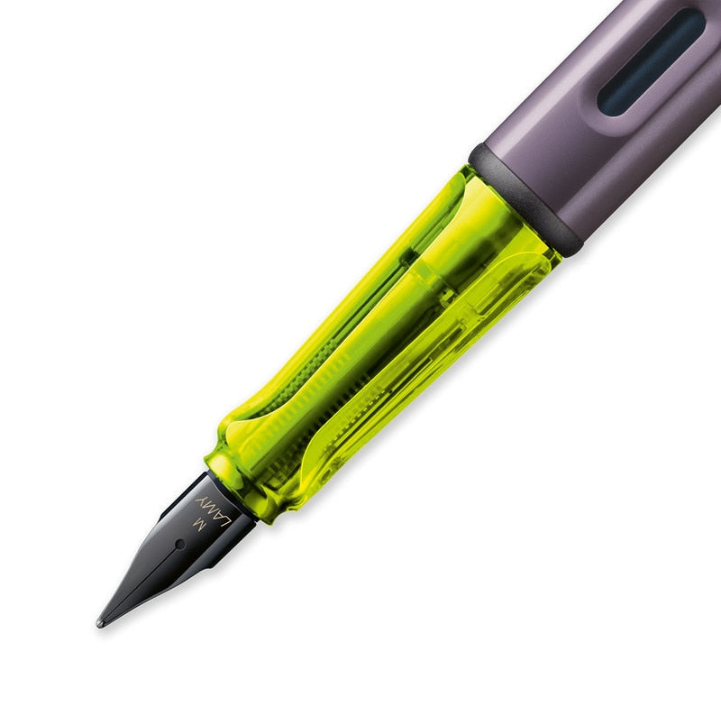LAMY AL-star (Aubergine) - Fine fountain pen close-up, featuring a black medium nib in a transparent neon grip, part of the special edition collection.