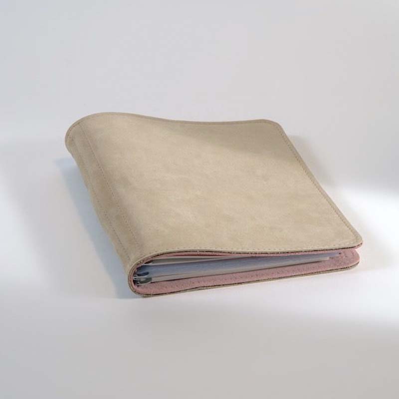 Taschenbegleiter SO_23 by Roterfaden, a soft leather cover in light beige, showcasing edges of papers inside, ideal for organizing planners and documents.