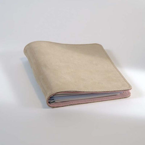 Taschenbegleiter SO_23 by Roterfaden, a soft leather cover in light beige, showcasing edges of papers inside, ideal for organizing planners and documents.