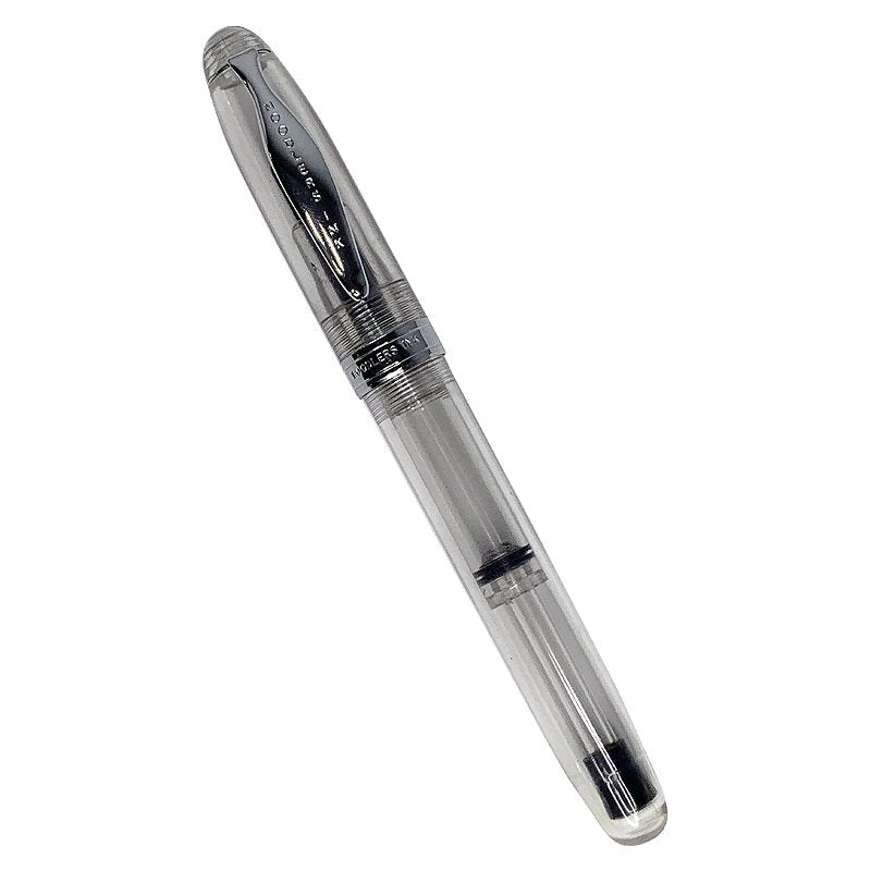 Ahab Flex - Clear Demonstrator: Transparent fountain pen with clear acrylic barrel, metal cap, and flexible steel nib, showing piston-filling mechanism inside.