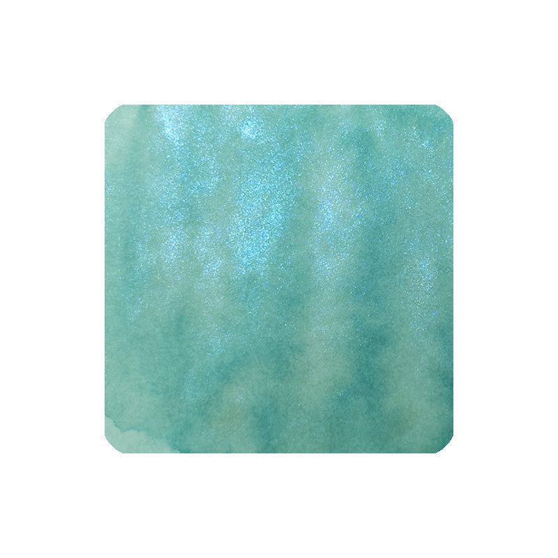 Dominant Industry Atlantis (Archival, Shimmer) fountain pen ink, 25ml, showcases a teal-green watercolor wash with a subtle pearlescent shimmer, ideal for vibrant writing.