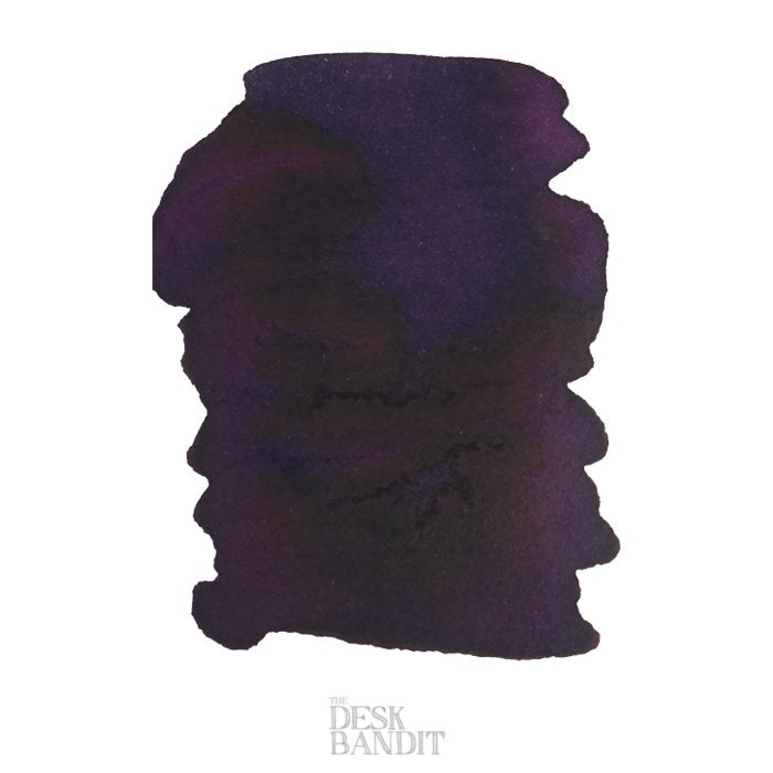 Robert Oster Barossa Grape - 2ml ink sample featuring a richly shaded purple/black blot on white background, showcasing its dye-based texture. Watermarked The Desk Bandit.