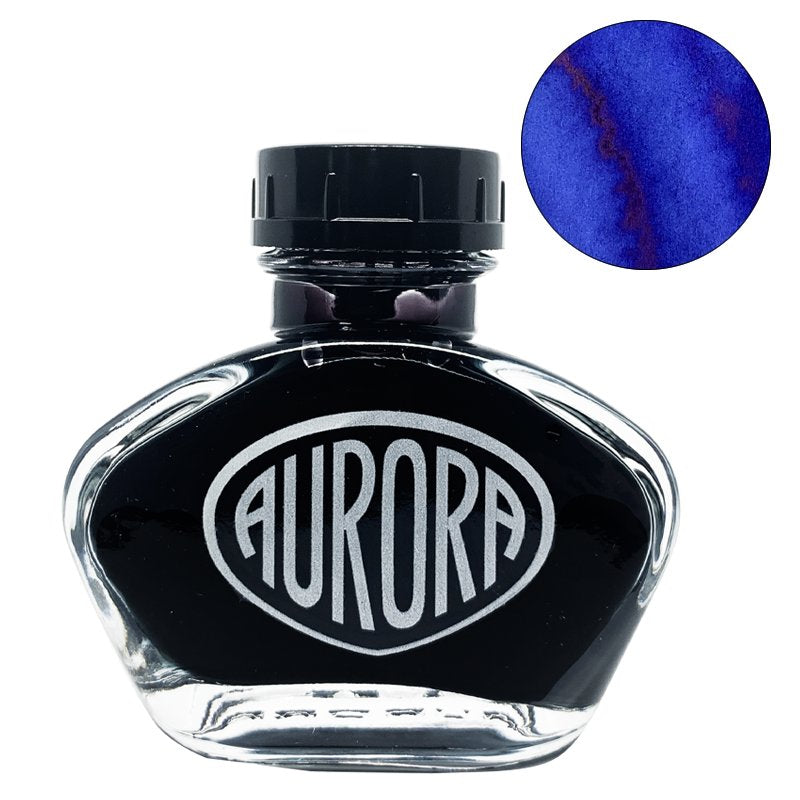 Aurora 100th Anniversary - Blue (55ml) ink bottle with clear glass body, black cap, silver logo, and a deep blue swatch with a reddish sheen.
