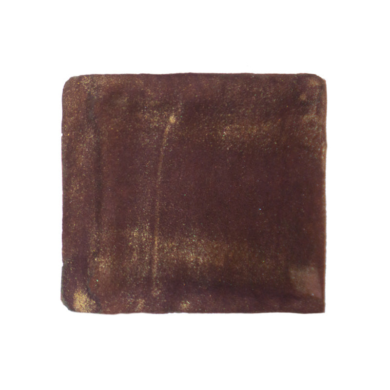 A swatch of burnt sugar coloured fountain pen ink with a shimmering finish.