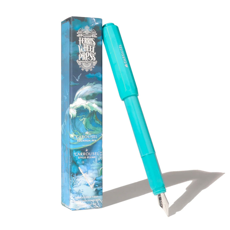 Ferris Wheel Press Carousel Fountain Pen - Tumultuous Tides (Fine), showcasing an aqua body and silver nib, alongside its ocean-themed decorative box.