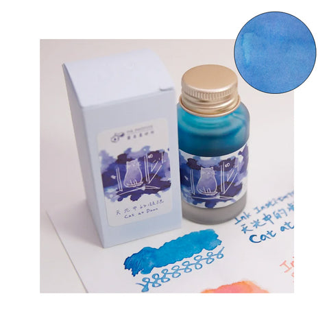 Cat at Dawn - 30ml fountain pen ink by Ink Institute, featuring a teal-blue hue, in a glass bottle with pastel-blue box, showcasing a cat in window design.