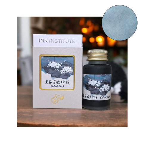 Ink Institute Cat at Dusk fountain pen ink, 30ml, featuring a dusky blue-gray shade with cat illustration on packaging, ideal for smooth writing and easy pen cleaning.