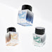 Sailor Dipton Ink Coral Humming - 20ml; a shimmery, glitter-filled dye ink for dip pens, shown in a square glass bottle with a black cap.