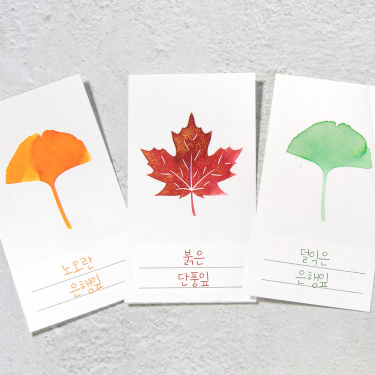 Wearingeul 'Ash Leaf' Ink Swatch Cards featuring watercolor leaf silhouettes with Korean captions, showcasing fountain pen ink characteristics on 200gsm paper. Pack contains 50 cards.
