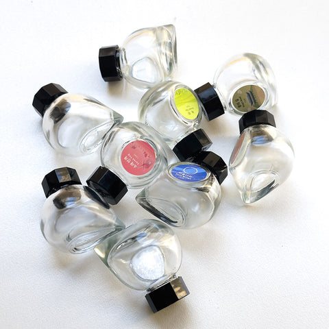 Colorverse Empty 15ml Bottle with black, faceted lid and color-coded cap, ideal for fountain pen ink samples; supports Desk Bandit's community donation initiative.