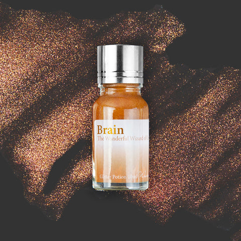 Wearingeul Brain (Wizard of Oz) Glitter Potion - 10ml vial with bronze-orange shimmer, ideal for transforming fountain pen ink into a shimmering masterpiece.