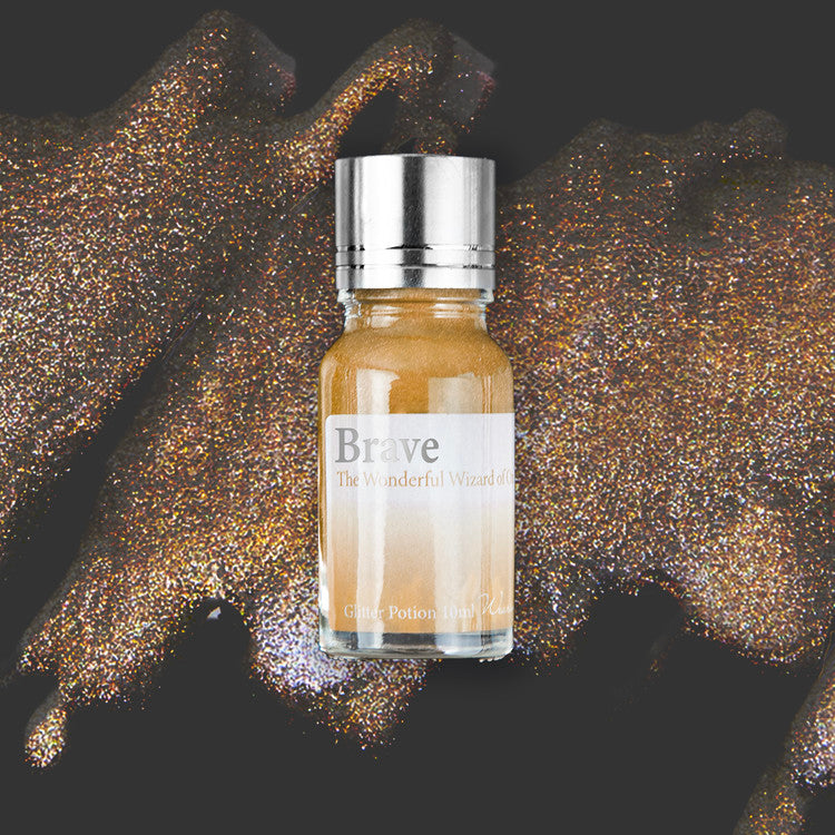 Wearingeul Brave (Wizard of Oz) Glitter Potion, 10ml vial. Silver lid, gold-copper shimmer. Add-on for fountain pen ink, enhancing shimmer effect.