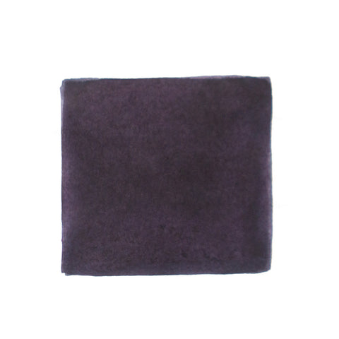 KWZ Ink's Grey Plum fountain pen ink, 60ml, shown in a plush, purplish-gray cloth, exemplifies handcrafted quality and unique color, aligning with Desk Bandit's specialty writing supplies.