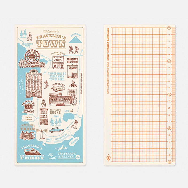 Traveler's Company Guide Sheet / Shitajiki 2024 (Regular) features a whimsical travel-themed illustration and a 5mm grid with a 20cm ruler, perfect for fountain pen-friendly notebooks.