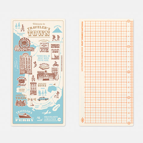 Traveler's Company Guide Sheet / Shitajiki 2024 (Regular) features a whimsical travel-themed illustration and a 5mm grid with a 20cm ruler, perfect for fountain pen-friendly notebooks.