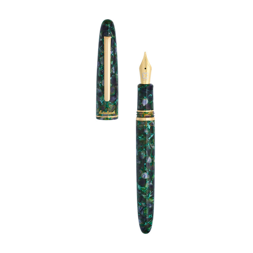 Esterbrook Estie Jurassic Gold Fude fountain pen in green-black marbled resin, gold-plated trim, gold nib, cap removed, showcasing craftsmanship for writers and illustrators.