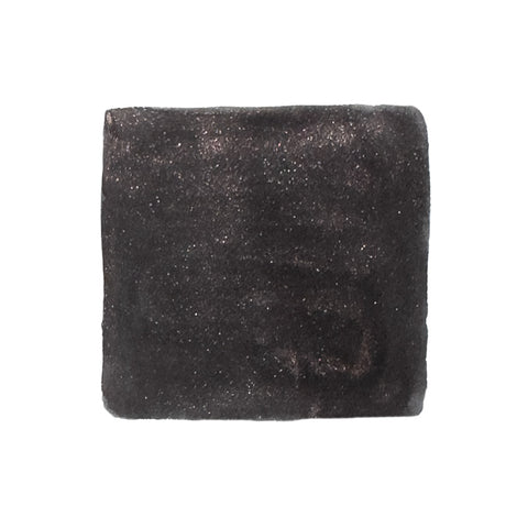 Shogun by Kenzo Takada - 50ml, a dye-based, shimmering fountain pen ink by Jacques Herbin, depicted as a black charcoal briquette for Desk Bandit.