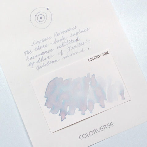 Colorverse Laplace Resonance & Loki Patera fountain pen ink set, featuring pastel blue/purple ink swatch with orbital diagram, includes 65ml and 15ml bottles, swatch cards, and brochure.