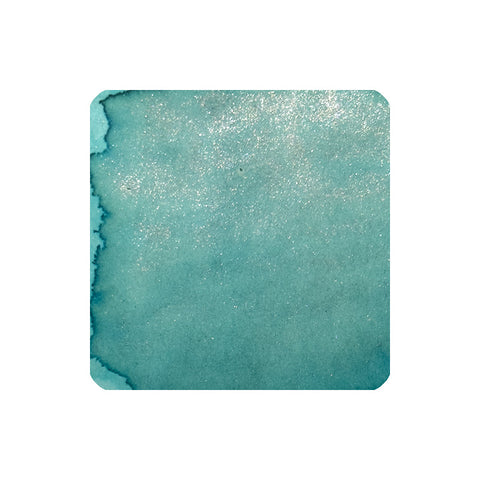 Dominant Industry Les Falaises a Étretat (Shimmer) fountain pen ink, 25ml, in a teal-blue watercolor wash with silvery shimmer, showcasing its unique, artistic texture.