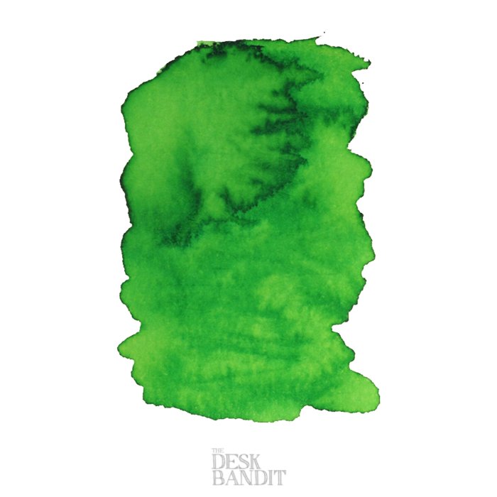 Light Green - 2ml ink sample showing uneven saturation and feathering on white paper, with THE DESK BANDIT logo faintly visible at the bottom.