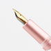 Moonman M2 Plus (Pink) fountain pen features a fine iridium nib and pink barrel, highlighted in a close-up of the nib section.