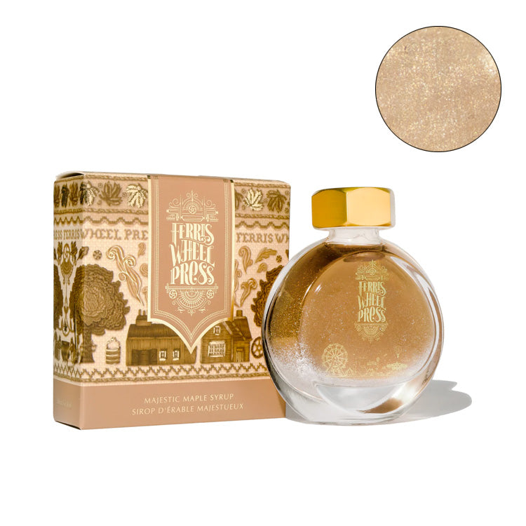 Ferris Wheel Press Majestic Maple Syrup fountain pen ink in 38ml glass bottle with gold cap, alongside decorative gift box with woodland motifs.