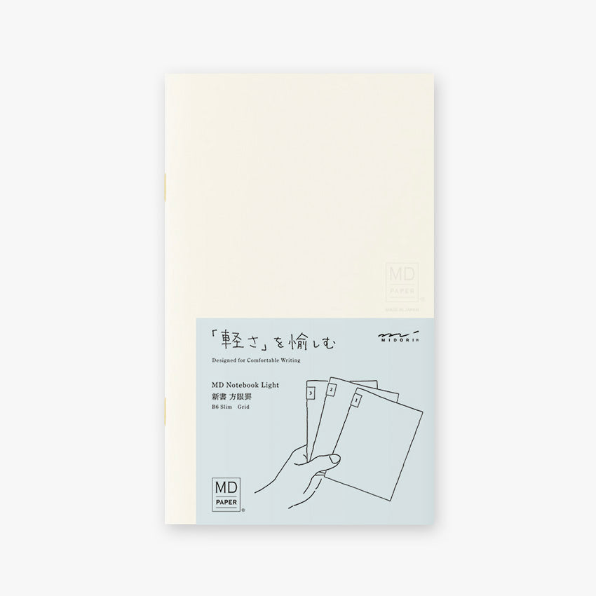 Midori MD Notebook Light – B6 Slim Grid (3 Pack) with off-white cover, pale blue band, and Japanese text promoting lightweight portability.