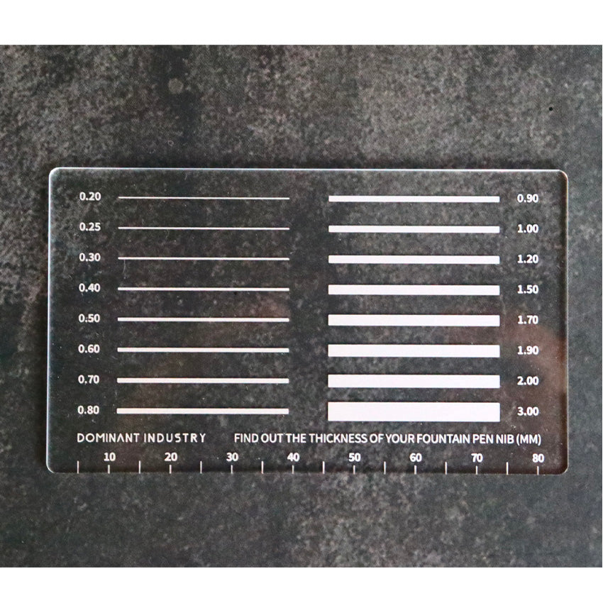 Measure My Pen MM Pad by Dominant Industry, a clear acrylic tool for measuring fountain pen nib widths, featuring etched millimetre markings for precise writing and drawing.