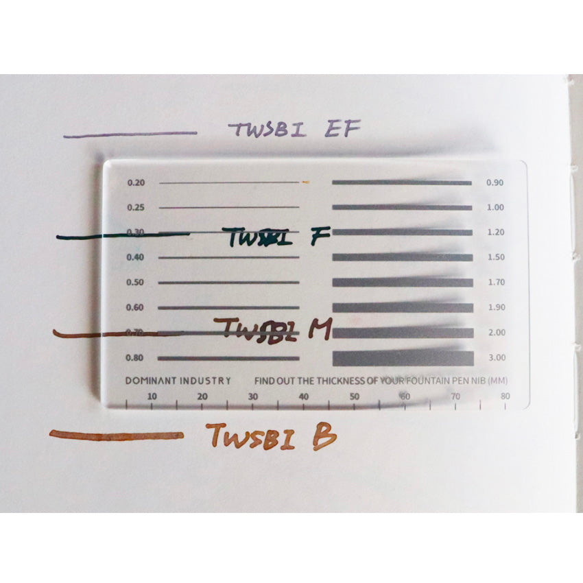 Measure My Pen MM Pad by Dominant Industry, a transparent gauge for assessing fountain pen nib sizes from 0.20 to 3.00 mm, ideal for precise writing.