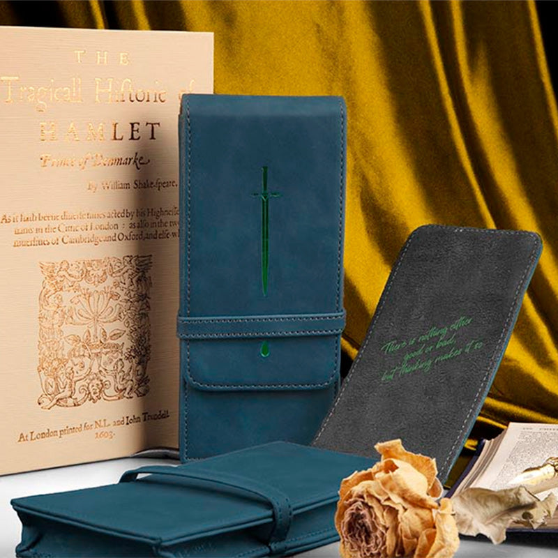 Wearingeul World Classic Literature Pen Pouch (Hamlet) featuring a teal-blue faux-leather cover with sword embossing and Hamlet quote, displayed with a facsimile book and dried roses.