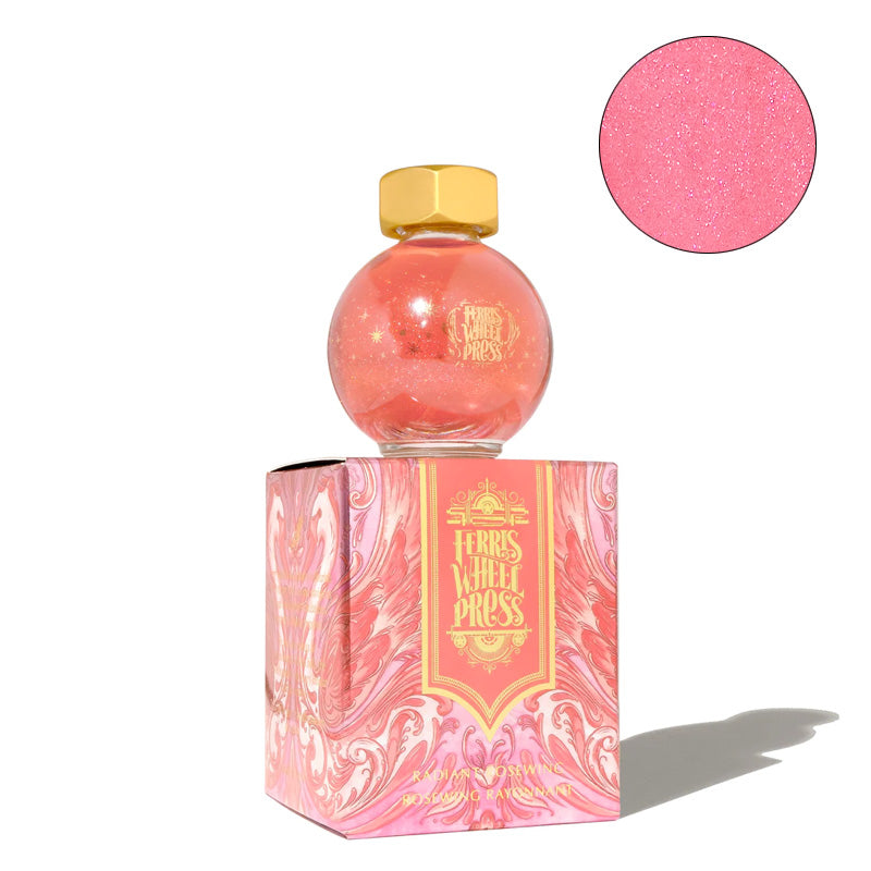 Ferris Wheel Press The Wild Swans - Radiant Rosewing fountain pen ink, 20ml, in a spherical glass bottle with gold shimmer, atop matching pink marbled packaging.