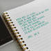 Wearingeul Reservoir Ring Note - A5 (Ruled) notebook with Korean text in green ink, showcasing its fountain pen friendly paper and minimalist gold wire coil binding.