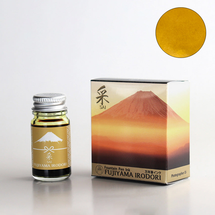 Teranishi Chemical Industry Sai Fujiyama Irodori fountain pen ink, 12ml bottle with silver cap, beside box featuring Mount Fuji artwork. Golden-yellow ink swatch shown.