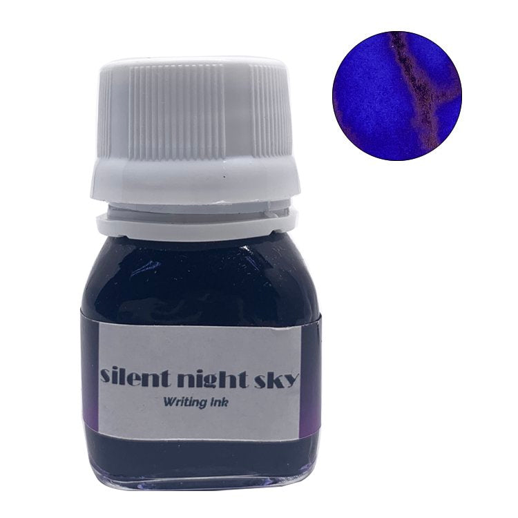 Silent Night Sky - 20ml bottle of deep blue Krishna ink, showing an ultramarine core with purplish outline and coppery sheen swatch. Handcrafted in Kerala.